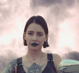 Woman with tattoos in smoky background